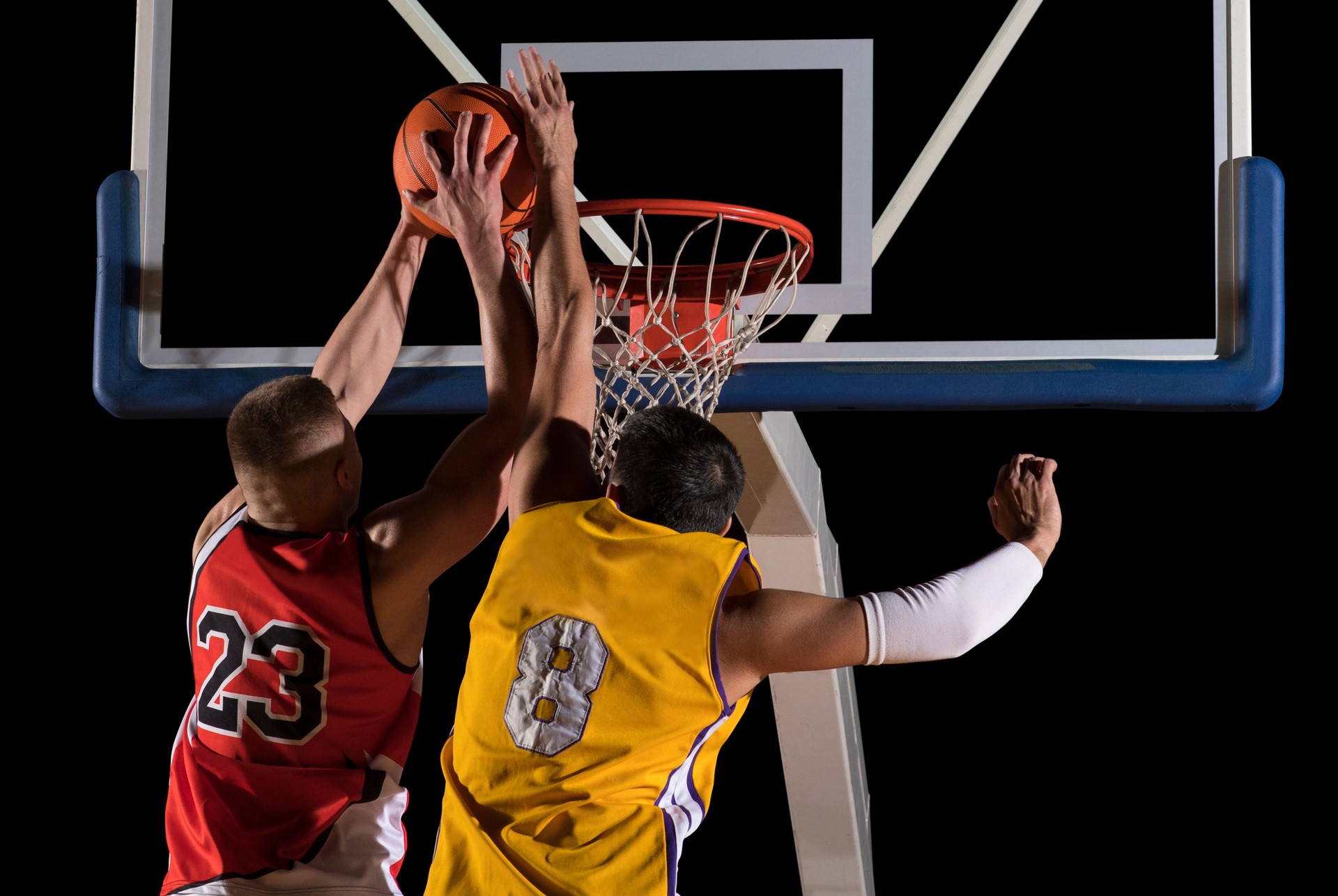 Two basketball players in action. Blocked shot